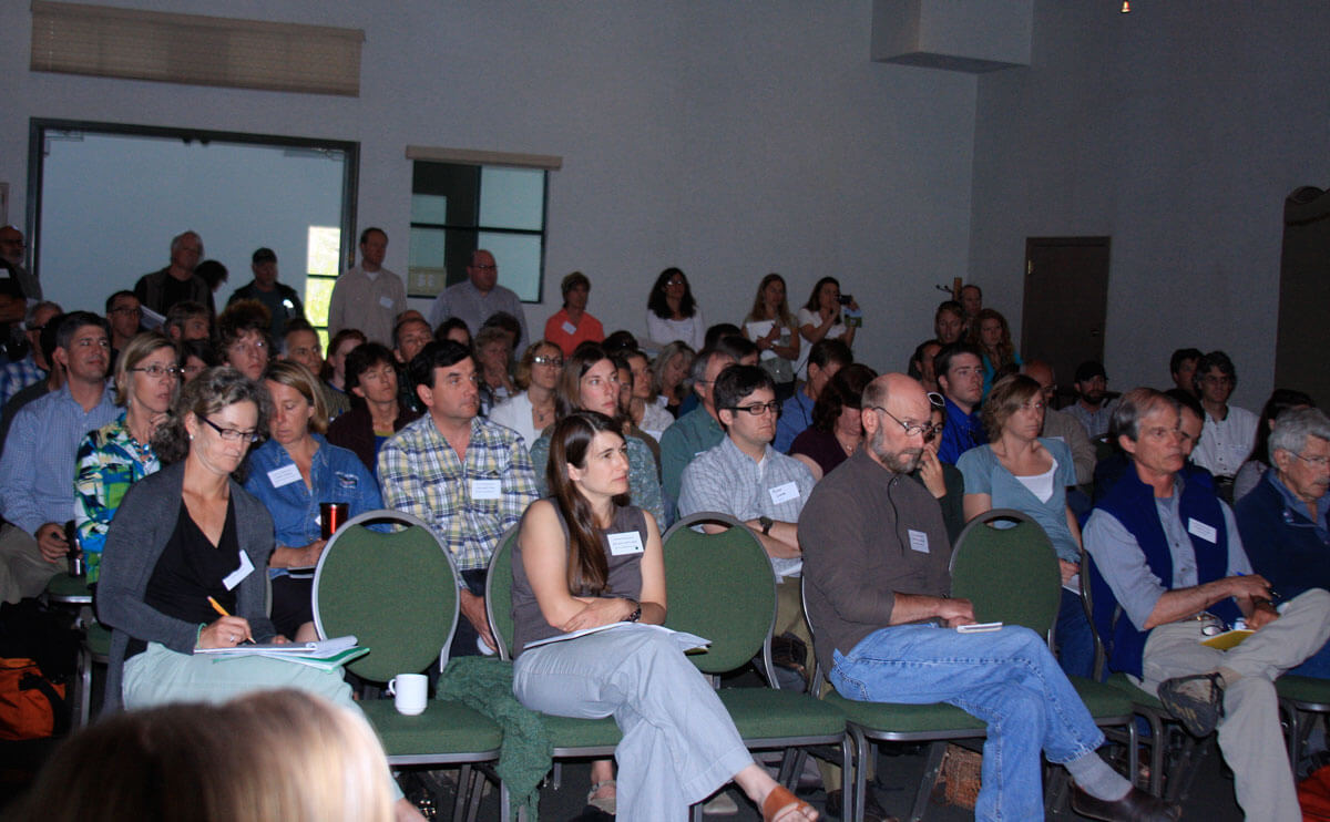 people sitting listening to a presentation
